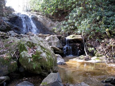 Welcome To Tennesse
If you happen to be traveling North on I-26 and have just entered Tennessee, stop at the very first Rest Stop and Welcome center. Just across the Interstate is Clear Branch Falls.

Go under I-26 and turn right at the stop sign. Proceed past the Church and as you descend down the hill keep a lookout on your left. Just past the last house is Clear Branch Falls (upper). After that keep an eye out and you will see Clear Branch Falls (lower)


