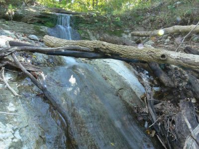 Fishin Hole
The most remarkable thing about this falls was the lady there that was fishin in the Clinch River.

She was alone so I tried to reassure her I am to loo old to be a threat. She didn't seem to worried anyway and the fishin pole seemed pretty deadly to me. 

Took my photos of a trashed waterfall and left, wondering if waterfalls by the road is where tires go to die.

Another one of life's mysteries that I'll work on when I get the urge to venture forth on another solo mission.
