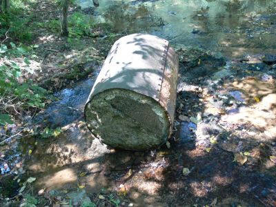 Boiler?
I found this near an old power plant t Burgess Falls, TN. 

Have no idea what it could be but, thought it might be an old boiler except it has concrete in the bottom?

Any info appreciated.
